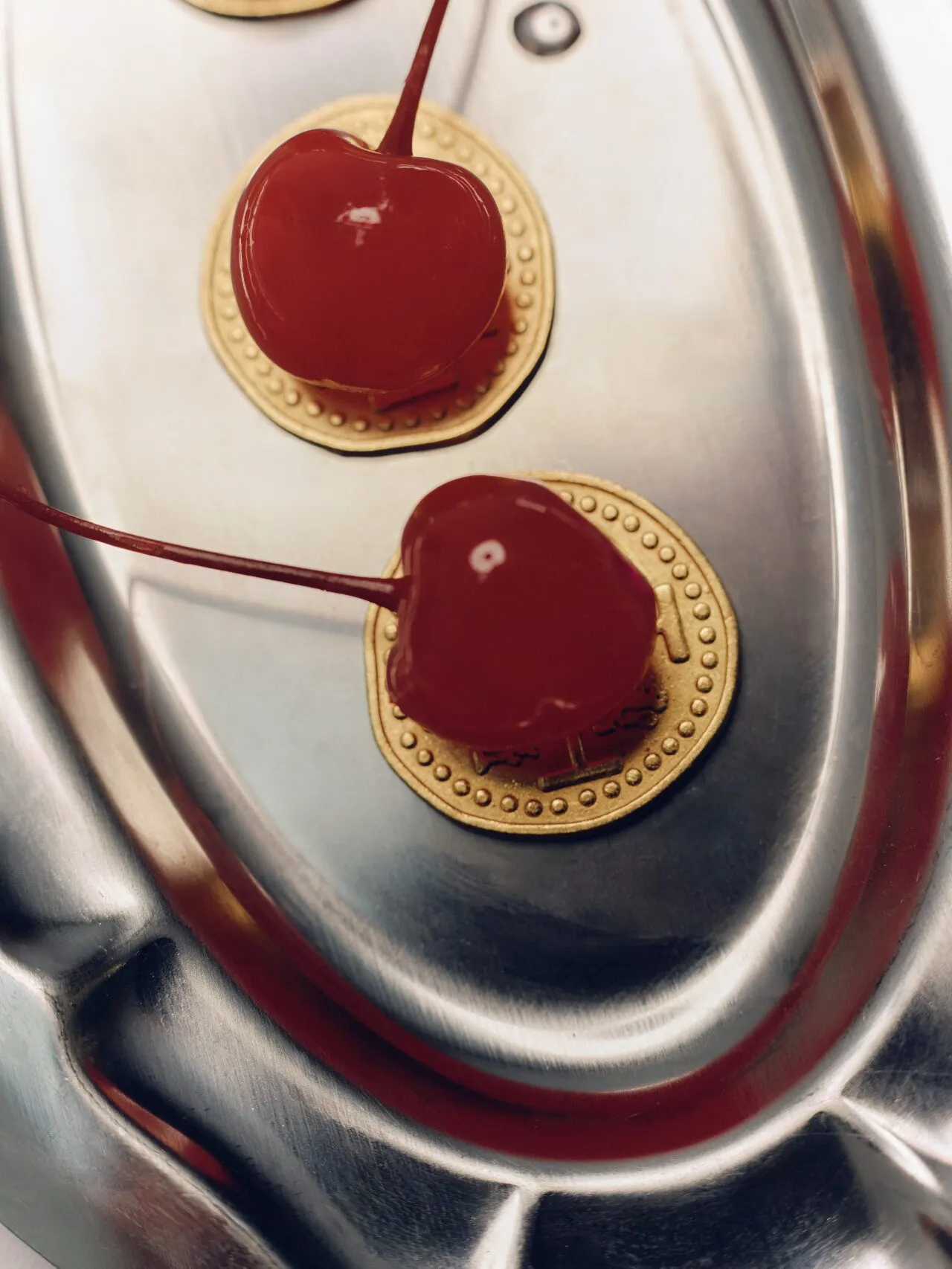 Cherries piled on a silver tray.